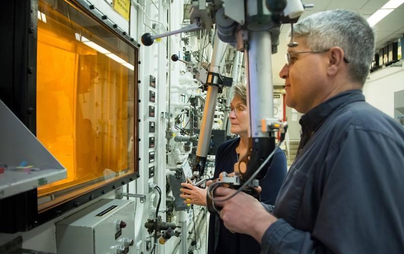 Radiochemical technicians David Denton and Karen Murphy use hot cell manipulators at Oak Ridge National Laboratory during the production of actinium-227.