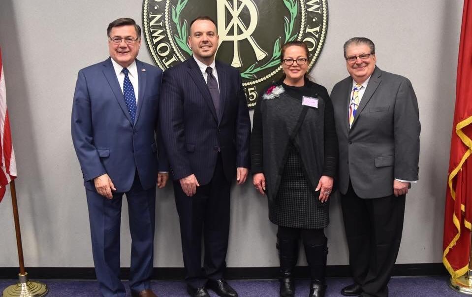 With Cathy Cutler, recipient of the 2019 Town of Brookhaven (TOB) Women in Science Award are, from left, Edward Romaine, TOB Supervisor; Dan Panico, Councilman (District 6); and Louis Marcoccia, TOB Receiver of Taxes. Cutler received the award for her scientific accomplishments in the field of radioisotopes. She was honored at a ceremony held at Brookhaven Town Hall on March 21.