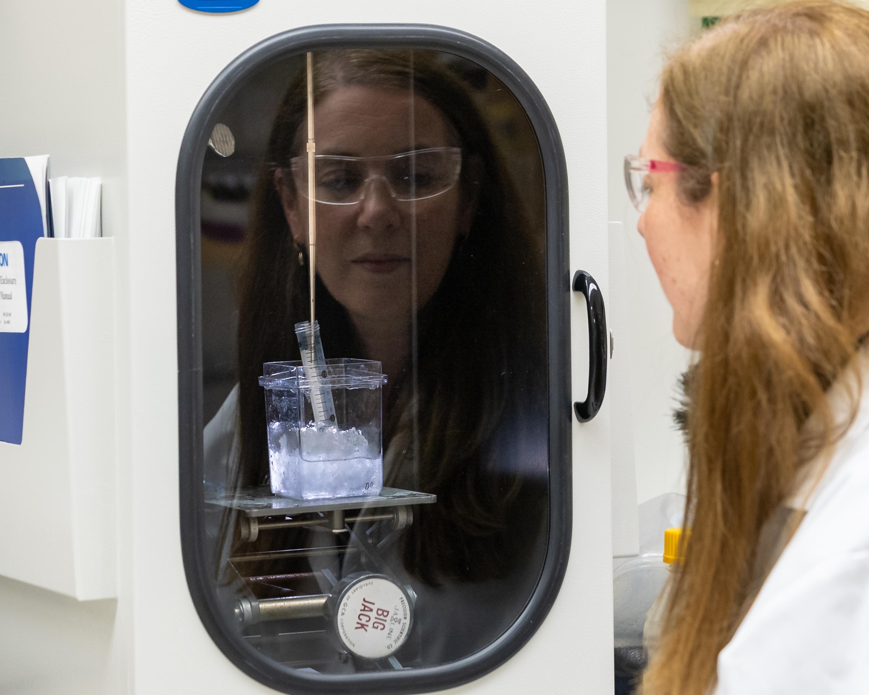 Image courtesy of Carlos Jones, Oak Ridge National Laboratory Researcher Sandra Davern looks at non-radioactive metal ions enclosed in biodegradable polymers in her lab at Oak Ridge National Laboratory. Her work is paving the way for enclosing isotopes in the same polymers for targeted treatment of cancer cells.