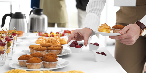 woman taking snack during coffee break